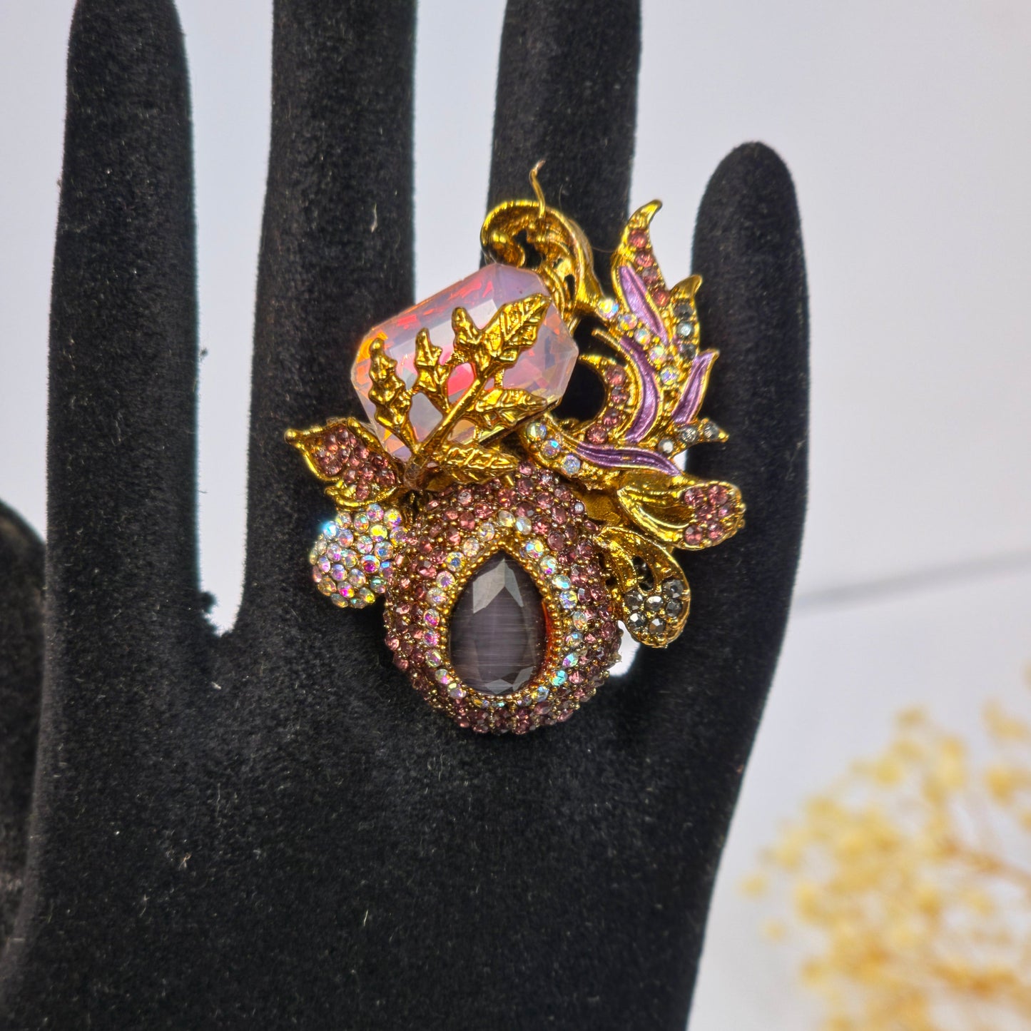 Decorative ring with gemstones on a black glove