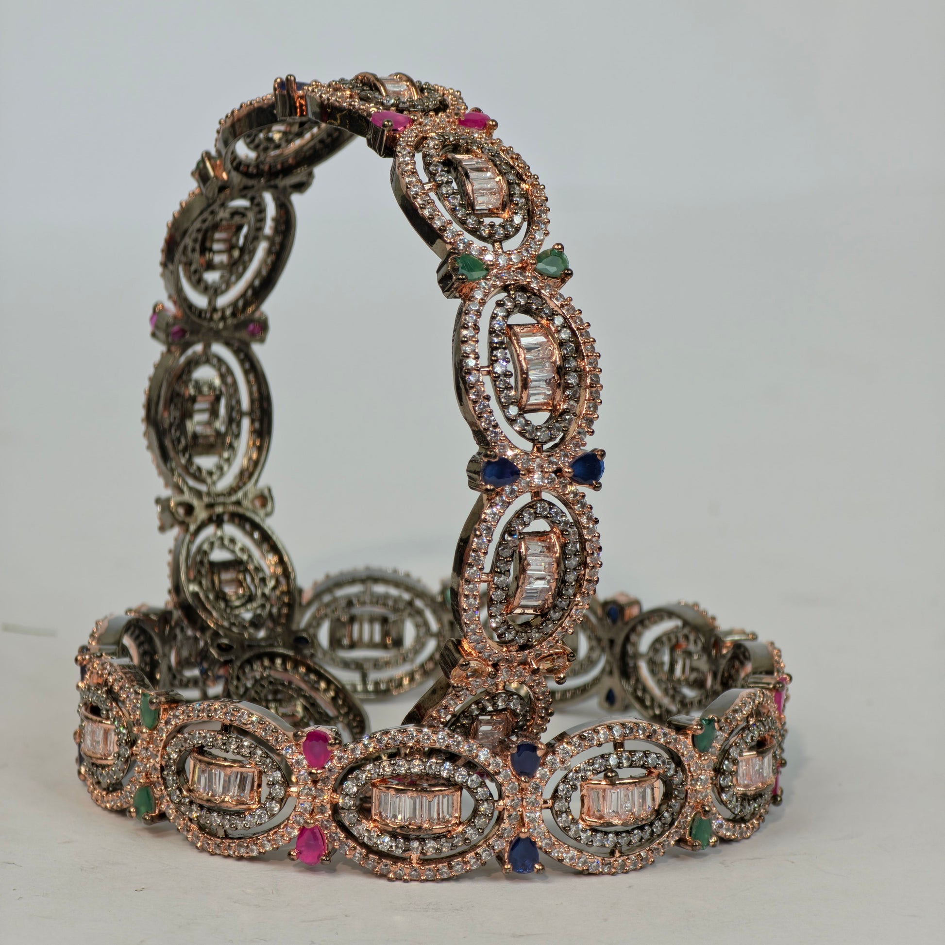 Decorative bracelet with gemstones on a light gray background
