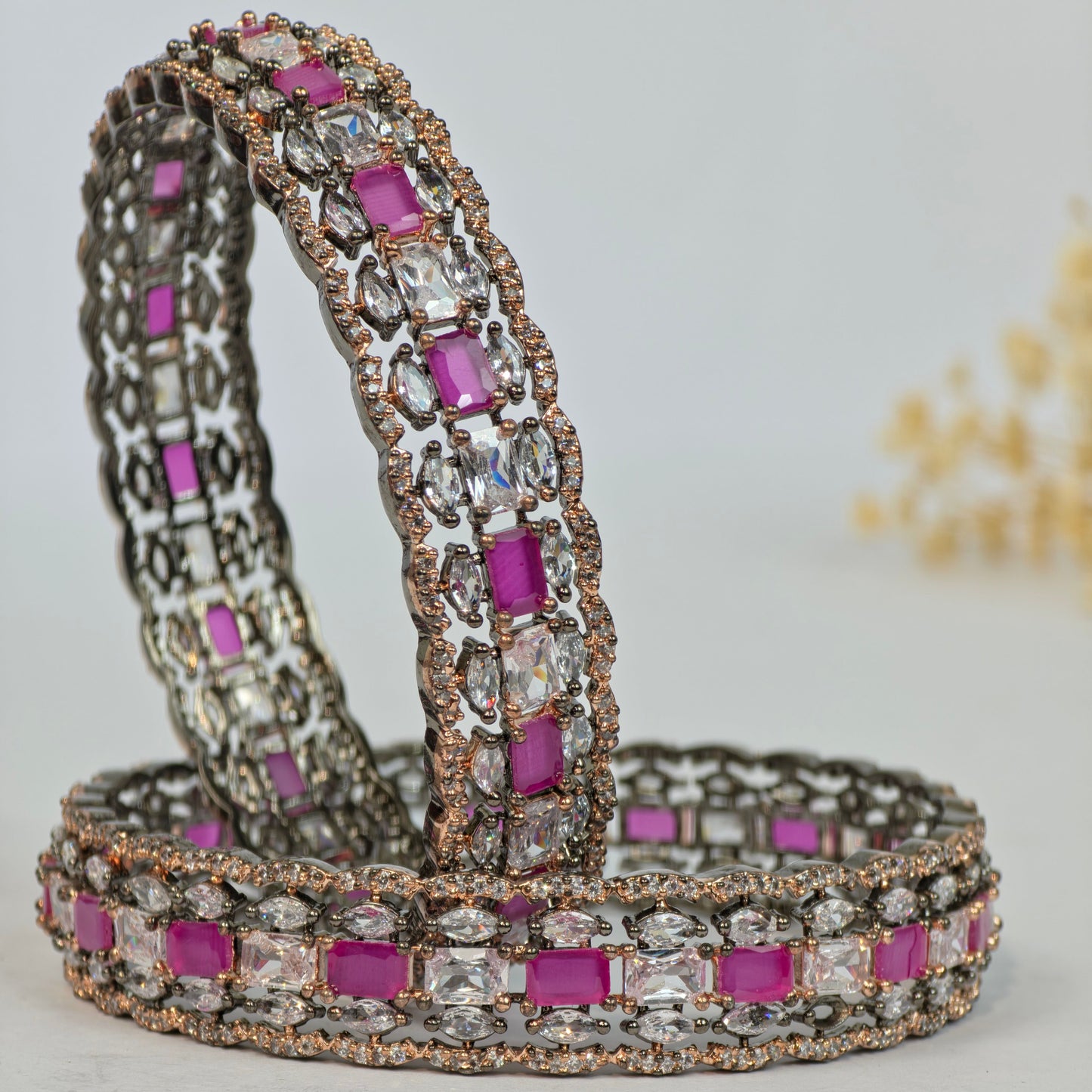 Bracelet with pink and clear gemstones on a light gray background