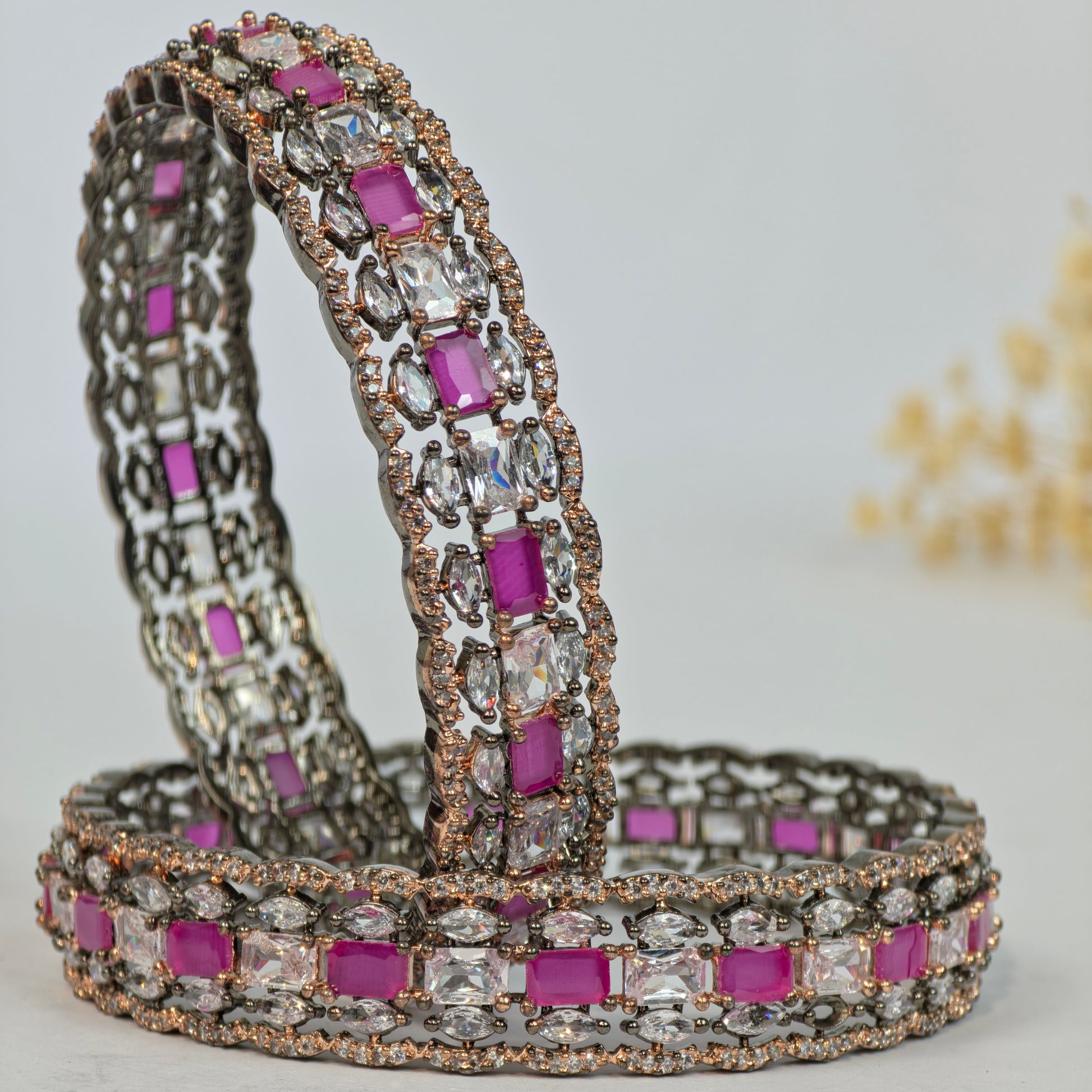 Bracelet with pink and clear gemstones on a light gray background