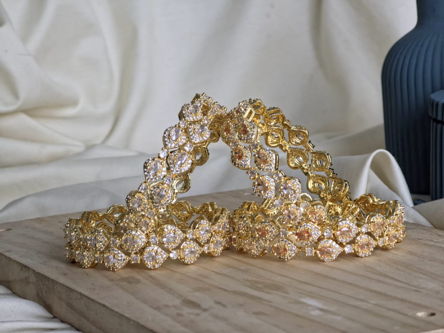 Gold tiara with crystal embellishments on a wooden surface